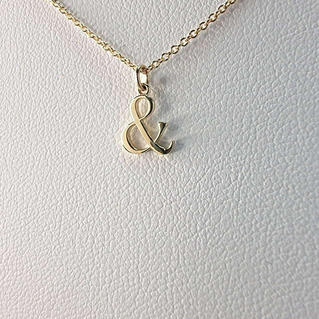 And Symbol Necklace on a white textured background
